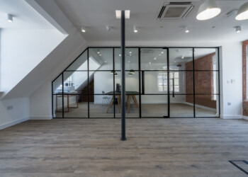 Crittall-style detailing at Kryolan Covent Garden room in eaves with crittall style glazed room divider