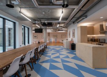 Consensys kitchen space with geometric floor office kitchen space with long table and light blue and white geometric floor
