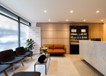 Reception area at Define Clinic reception area with slatted timber walls and white marble reception desk