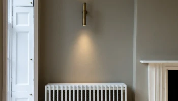 Interior at 21 Bedford Square Grey wall with radiator and uplighter