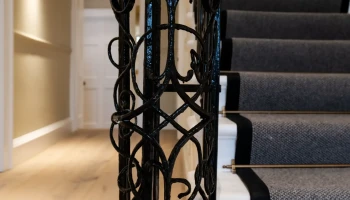 Ornate wrought iron newel post Ornate wrought iron newel post on Georgian staircase