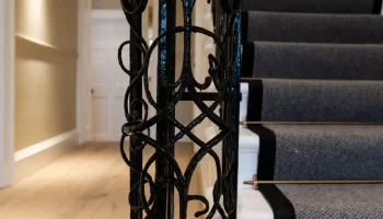 Ornate wrought iron newel post Ornate wrought iron newel post on Georgian staircase