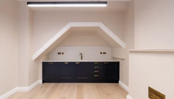 Office kitchen space at 21 Bedford Square small luxury black kitchen in alcove