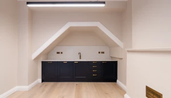 Office kitchen space at 21 Bedford Square small luxury black kitchen in alcove