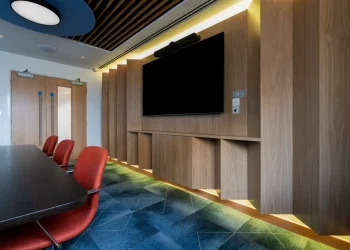 Interior of conference facility at Olympia Henley Suite tv screen on timber panelled wall at conference suite
