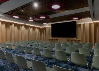 Conference facility at Olympia Henley Suite Conference room with modern timber panelled walls, large screen and rows of chairs