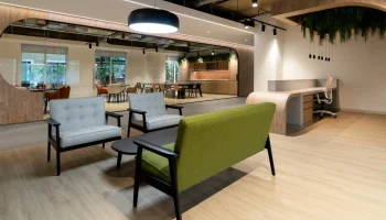 Reception seating area in ground floor office at Arlington Square Reception seating area with large green sofa and grey smaller sofas