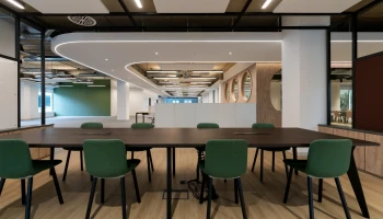Meeting area in ground floor office at Arlington Square Meeting area with dark wood table and green chairs