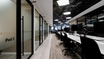 Open plan office floor with meeting pods at Acturis Hatton Garden Open plan office floor with meeting pods at Acturis office fit out in Hatton Garden